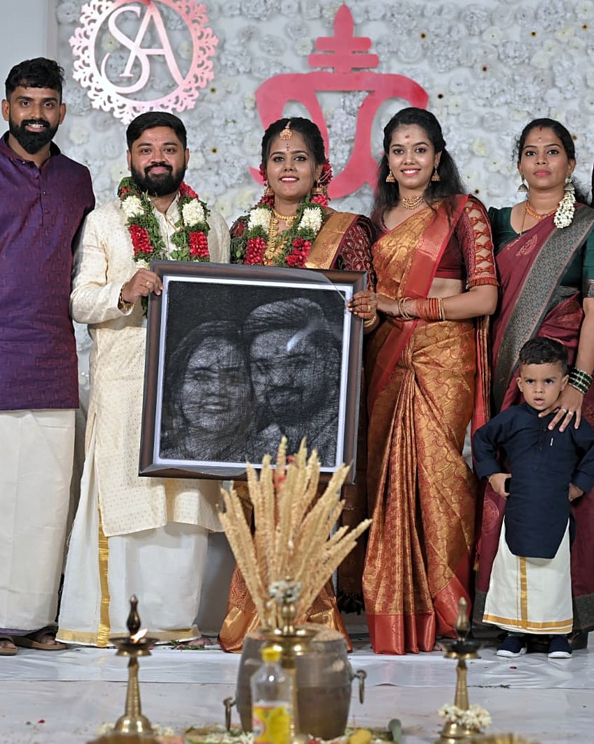 Framed thread portrait presented on a wedding stage