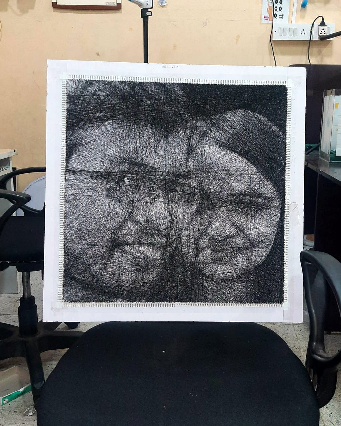 Couple thread portrait on a chair