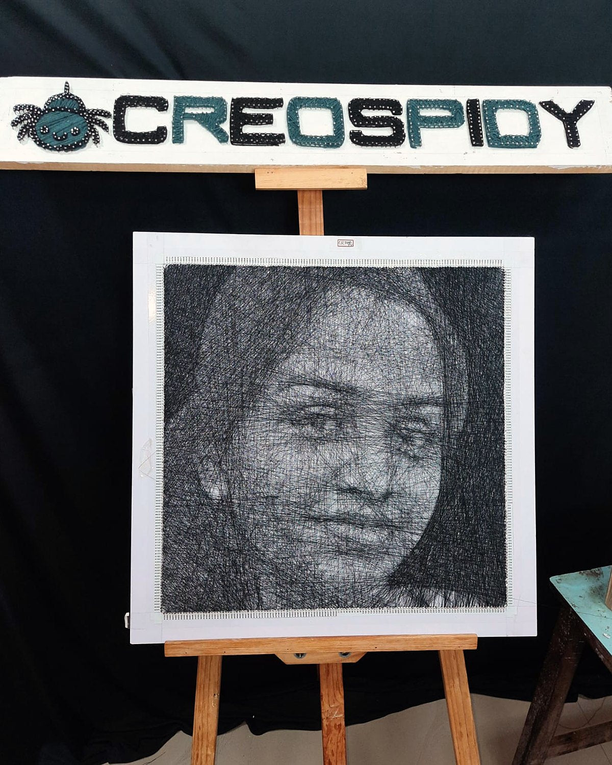 Thread portrait of a woman on the CreoSpidy studio easel